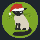 Siamese Santa Clause - Funny Christmas Cat Classic Round Sticker<br><div class="desc">Grouchy Siamese Cat Holiday Stickers. Funny cat wearing a Santa Clause hat. This annoyed kitty says Bah Humbug to wearing a ridiculous hat. These fun stickers are perfect for sealing the back of holiday envelopes. Visit Jenn’s Doodle World for more funny cat lover's products and cool gifts featuring this humourous...</div>