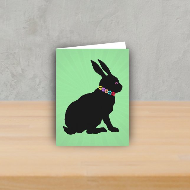 Side Profile sitting Black Rabbit Flowers Pink Eye Card (Sitting black silhouette bunny wearing colourful flowers on green Spring or Easter note card.)