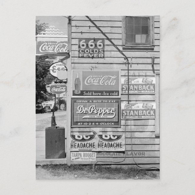 Signs on a General Store, 1938 Postcard (Front)