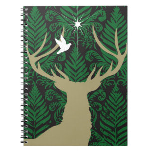 Silhouette of a deer, a dove and a star against a spiral notebook