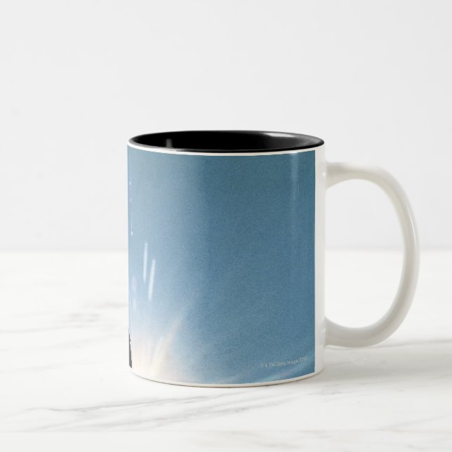 Silhouette of bald eagle flying in sky Two-Tone coffee mug (Right)