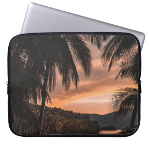 Silhouette of palm tree during golden hour laptop sleeve