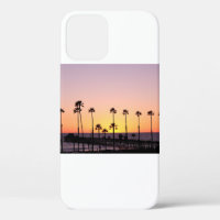 Silhouette of palm trees and dock during sunset