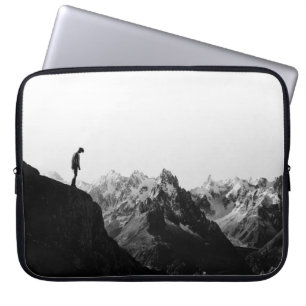 SILHOUETTE OF PERSON STANDING ON CLIFF IN FRONT OF LAPTOP SLEEVE