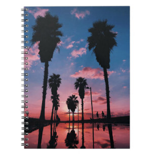 Silhouette of tree under cloudy sky notebook