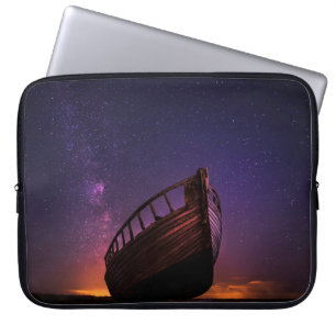 SILHOUETTE PHOTOGRAPHY OF SAILING BOAT ON BODY OF  LAPTOP SLEEVE