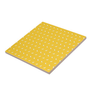 Silhouettes of Small White Bananas on Yellow Tile