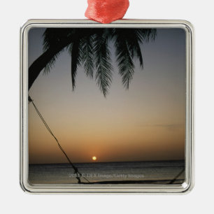 Silhuetted empty hammock at sunset metal tree decoration