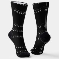 Silver hanging Xmas ornaments on black Socks