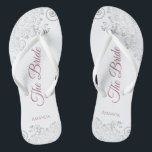 Silver Lace & Dusty Rose Script The Bride Wedding Jandals<br><div class="desc">Dance the night away with these beautiful wedding flip flops. Designed for the bride, they feature a simple yet elegant design with dusty rose or mauve pink script lettering on a white background and fancy silver grey lace curls and swirls. Beautiful way to stay fancy and appropriate while giving your...</div>