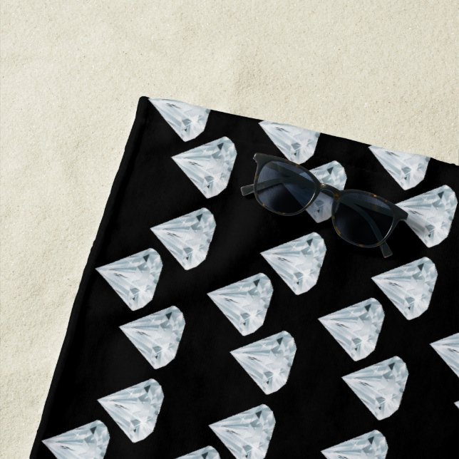 Silver shiny diamonds on black beach towel (In Situ)