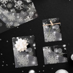 Silver Snowflakes Sparkles And Lights On Black Wrapping Paper Sheet<br><div class="desc">Winter themed wrapping paper sheet design featuring faux silver snowflakes,  sparkles and lights on a black background.</div>