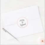 Simple and elegant names blush pink wedding classic round sticker<br><div class="desc">Simple and elegant names blush pink and white wedding Classic Round Sticker. It displays your names on white with a pink border. It coordinates with our "Blush pink tropical leaves" wedding collection.</div>