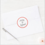 Simple and elegant names living coral wedding classic round sticker<br><div class="desc">Simple and elegant names living coral and white wedding Classic Round Sticker. It displays your names on white with a coral border. It coordinates with our "living coral tropical leaves" wedding collection.</div>