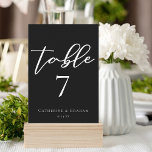 Simple Chic Black Wedding Table Number Card<br><div class="desc">Simply chic and stylish,  our minimalist winter wedding collection features elegant cursive typography for your modern reception. Guide your guests to their table with eye catching bold white script on a black background on these reception table number seating chart cards.</div>