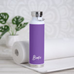 Simple Elegant Name Purple Modern Water Bottle<br><div class="desc">Modern water bottle featuring a simple and minimalist design with your name in an elegant script over a grape purple background.  A cute design perfect for a girly girl.</div>