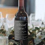 Simple Elegant White on Black Wedding Thank You Wine Label<br><div class="desc">These wedding wine bottle labels are perfect for thanking special guests, family, or members of your bridal party. The white on black design is simple yet elegant with lacy script lettering reading Thank You for celebrating with us. There is space for the names of the couple, the wedding date, and...</div>