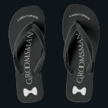 Simple Fun Groomsman Name & Bow Tie Wedding Jandals<br><div class="desc">These fun flip flops are a great way to thank the groomsmen at your wedding, and a wonderful way to give his feet a break after a long day! They feature a simple white on black design with his name at the top, the word "Groomsman" spelled out in classy letters...</div>