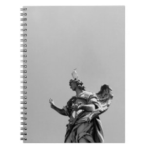 Simple, modern photo of seagull on top of statue notebook
