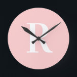 Simple Monogram Modern Blush Pink Round Clock<br><div class="desc">This is a simple, modern, personalised monogram design. This stylish design is in trending blush pink with stylish typography. It's perfect for a personalised gift or ideal as a new home decor accessory for yourself. Simply add your initial letter by typing it into the personalise this text box. Check out...</div>