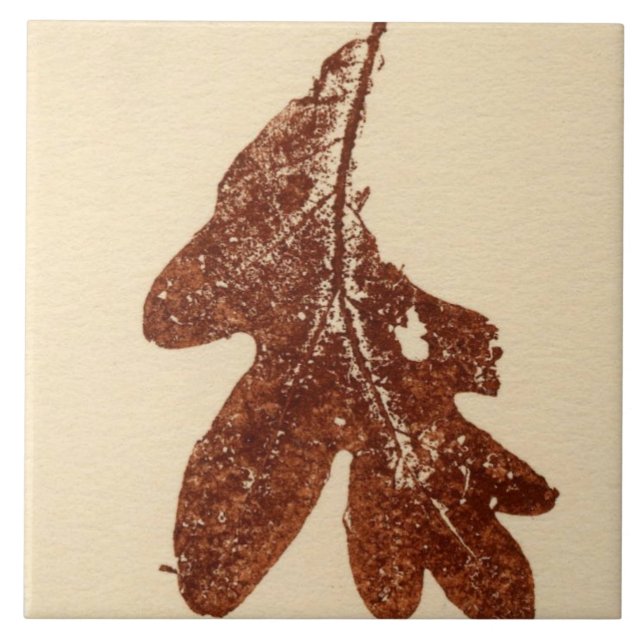 Single oak leaf nature printed in brown ink on tan tile (Front)