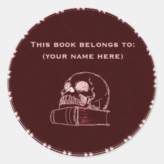Skull and a book, red classic round sticker