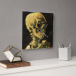 Skull with Burning Cigarette by Vincent van Gogh Square Wall Clock<br><div class="desc">Skull with Burning Cigarette by Vincent van Gogh is a vintage fine art post impressionism still life painting. A portrait of human skeleton smoking. Great image to use for anti-smoking products. Smoking kills 1, 000s every year, help someone to quit smoking today. Great image for Halloween or Día de los...</div>