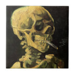 Skull with Burning Cigarette by Vincent van Gogh Tile<br><div class="desc">Skull with Burning Cigarette by Vincent van Gogh is a vintage fine art post impressionism still life painting. A portrait of human skeleton smoking. Great image to use for anti-smoking products. Smoking kills 1, 000s every year, help someone to quit smoking today. Great image for Halloween or Día de los...</div>