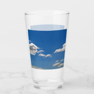 Sky is blue and white clouds are passing by glass
