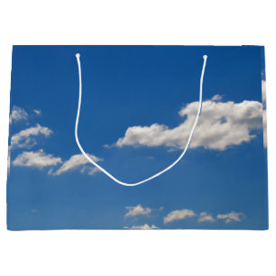Sky is blue and white clouds are passing by large gift bag