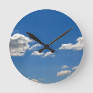 Sky is blue and white clouds are passing by round clock