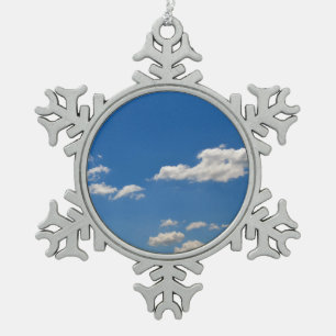Sky is blue and white clouds are passing by  snowflake pewter christmas ornament