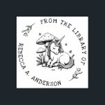 Sleeping Unicorn Toadstool Bookplate Stamp<br><div class="desc">Enchant your library with this personalised book stamp featuring a sleeping baby unicorn nestled beneath a magical toadstool. Surrounded by delicate ferns and fluttering butterflies,  this whimsical design adds a fairytale charm to every book. A dreamy gift for readers,  kids,  and lovers of fantasy and woodland magic.</div>