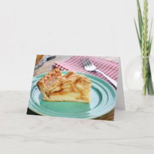Slice of fresh baked apple pie on plate card