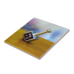 SlipperyJoe's Happy Hanukkah four-sided spinning t Tile<br><div class="desc">SlipperyJoe's Happy Hanukkah four-sided spinning top dreidel artistic Celebration Candles Jewish Hebrew Chanukah gifts decorations Judaism religion Hebrew letter Nun traditional toy children adult game cultural symbol metallic shiny finish wooden surface</div>
