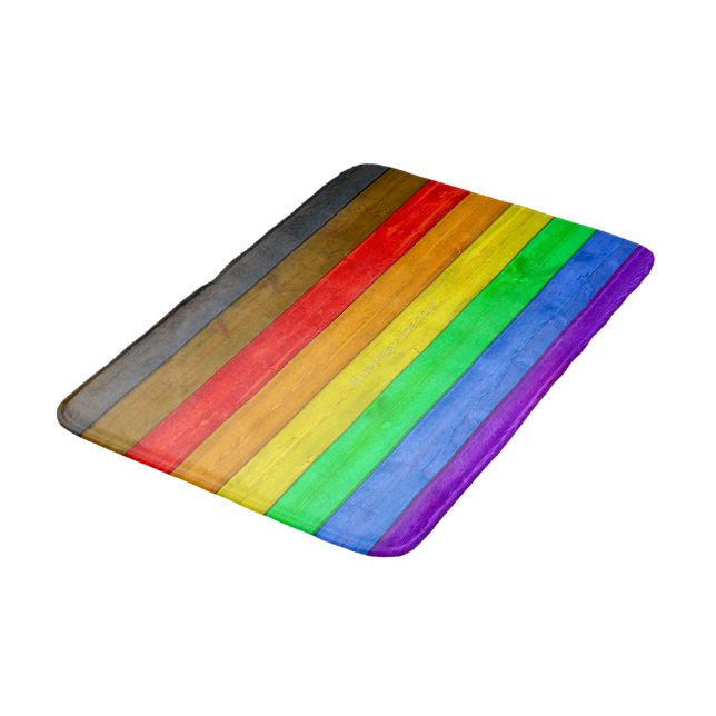 SlipperyJoe's Inclusive gay pride flag textured ru Bath Mat (Angled)