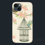 Small Birds Perched on a Branch and on a Birdcage iPhone 13 Case<br><div class="desc">Nancy Slocum's have painted many birds throughout the years. This image portrays two small blue and yellow birds perched on a branch surrounded by pink flowers and looking curious about a birdcage. Get this cool bird-themed art piece on your Zazzle product today.</div>