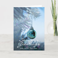 Small reflective blue bauble on white Christmas