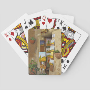 Small shope with artwork for sale on sidewalk playing cards