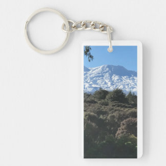 Snow-covered mountain green native bush foreground key ring