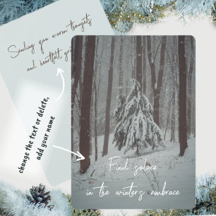 Snow-covered trees in the misty winter forest holiday card