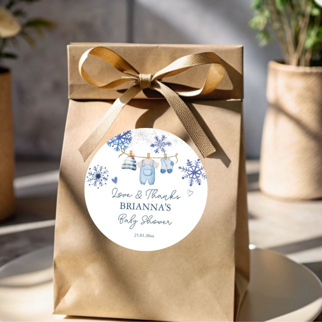 Snow in love snowflakes winter baby shower favour classic round sticker (Snow in love boho snowflakes blue clothes on line winter baby shower favor sticker template)