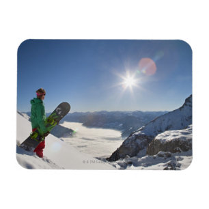 Snowboarder looking from mountain top magnet