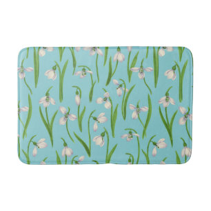 Snowdrops on pool blue bath mat