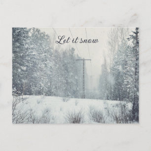 Snowfall in the winter forest  holiday postcard