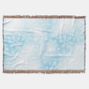 Snowflakes and lights on blue throw blanket