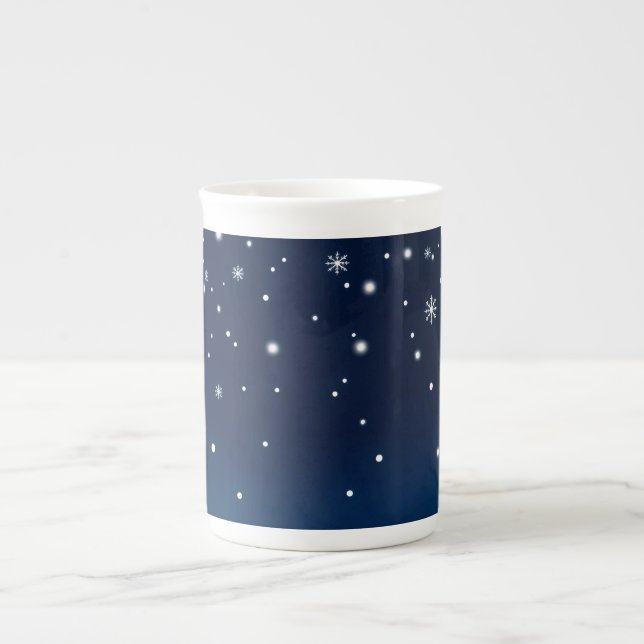 snowflakes gently descending against a deep blue s bone china mug (Front)
