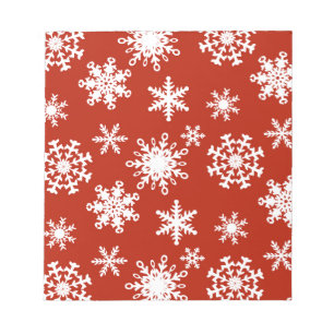 Snowflakes in white on red background notepad