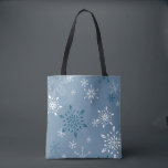 Snowflakes on a blue background tote bag<br><div class="desc">Snowflakes on a blue background Tote Bag - A two sided rugged tote with two snowflake scenes one on each side. The dark blue background is identical and so are the snowflakes but one side has a larger print, so the snowflakes are just a bit bigger. This bag would be...</div>