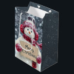 Snowman Holding a Merry Christmas Sign Medium Gift Bag<br><div class="desc">A cheerful snowman,  wearing red earmuffs and a matching scarf,  holds a sign that reads "Merry Christmas" amid a snowy background</div>